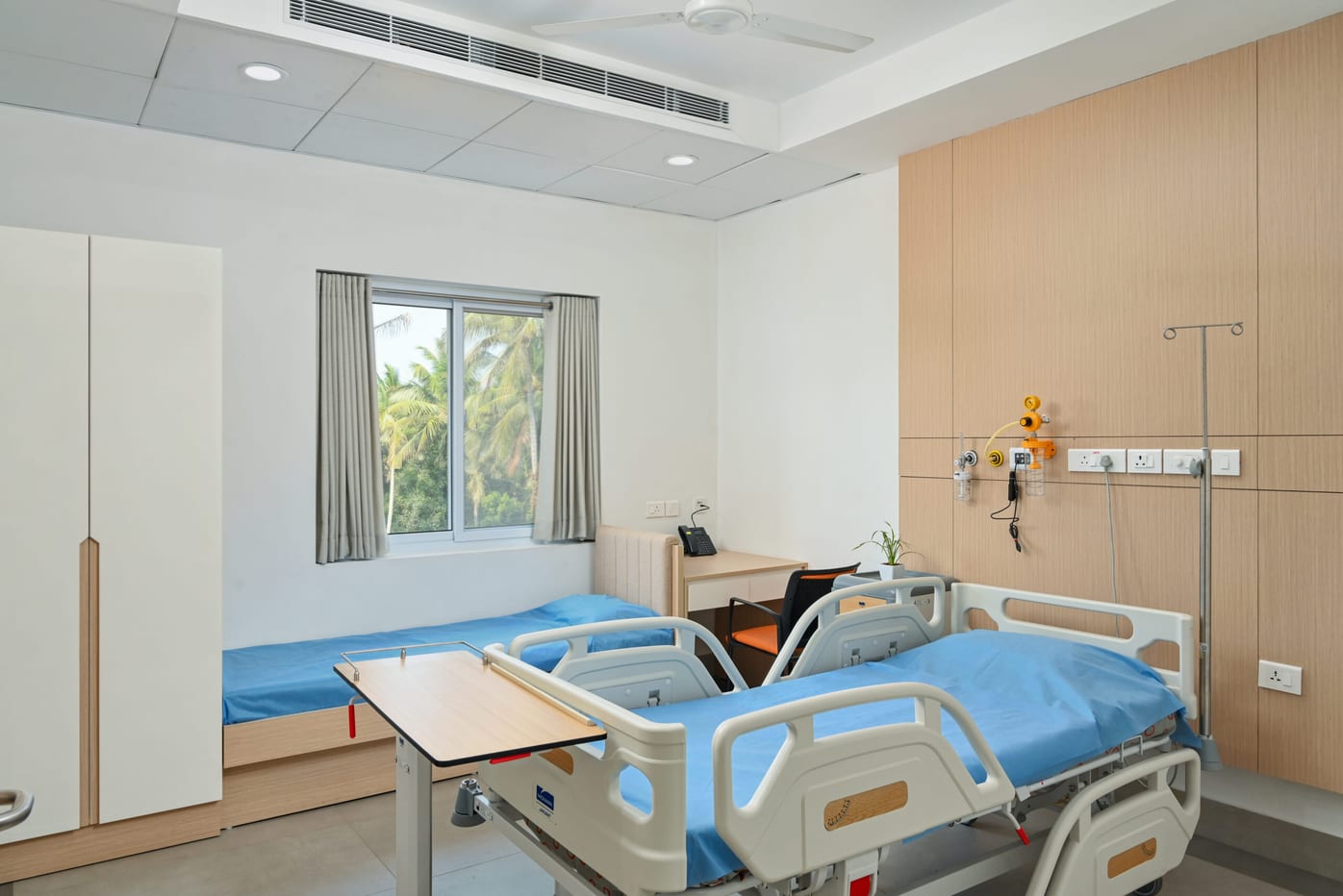 Bright private patient room with a hospital bed and window