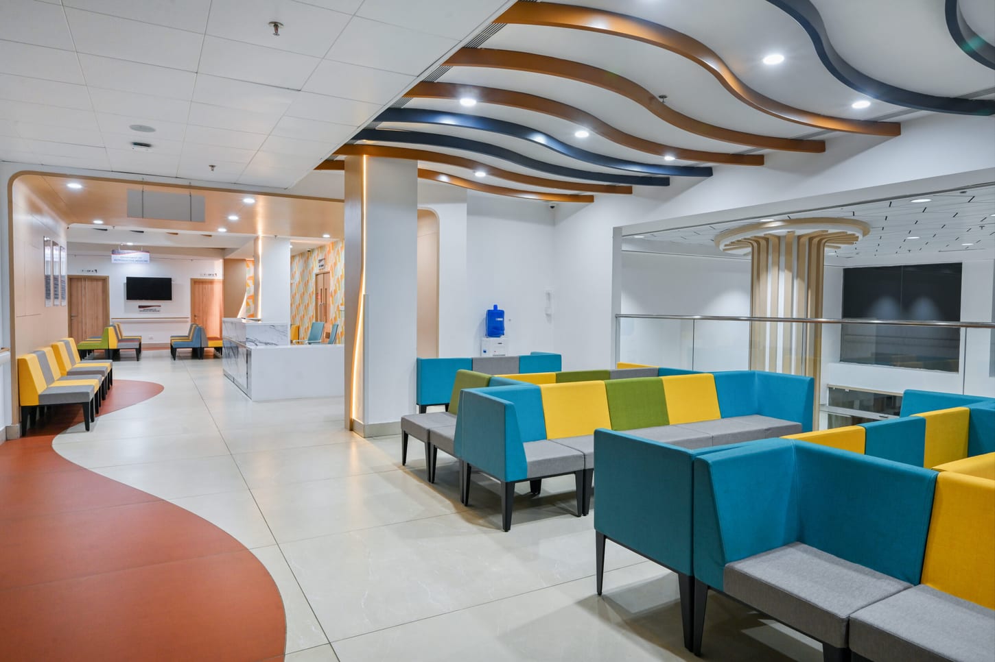 Waiting lounge with colourful modular seating and a curved ceiling